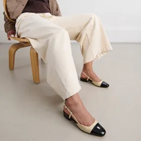 Open back ballet flats in black and beige patent leather